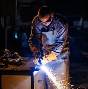Cutting metal with plasma equipment Worker cutting metal with plasma equipment on plant.